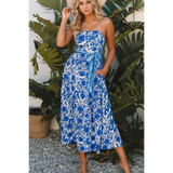 woman wearing a blue floral maxi dress affordable sleeveless midi dress with waist tie and pockets