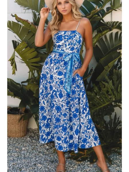 woman wearing a blue floral maxi dress affordable sleeveless midi dress with waist tie and pockets