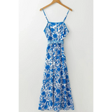 blue floral maxi dress affordable midi dress with spaghetti straps and decorative waist detail image hanging up 