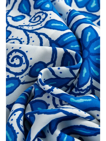Close-up of fabric with blue floral print pattern for blue floral maxi dress affordable by Trendsi