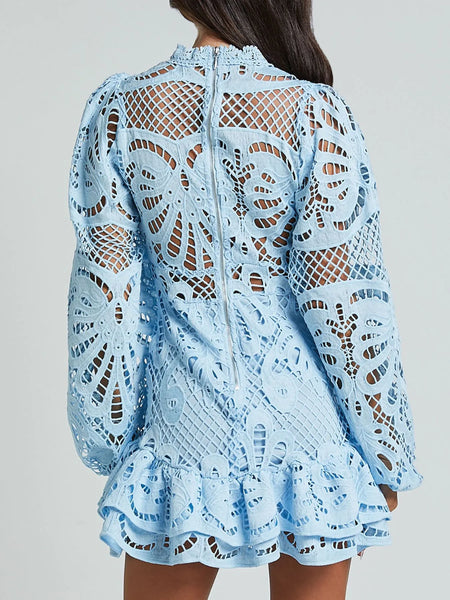 Babe Beachwear white lace mini cocktail dress with long sleeves and intricate floral patterns
