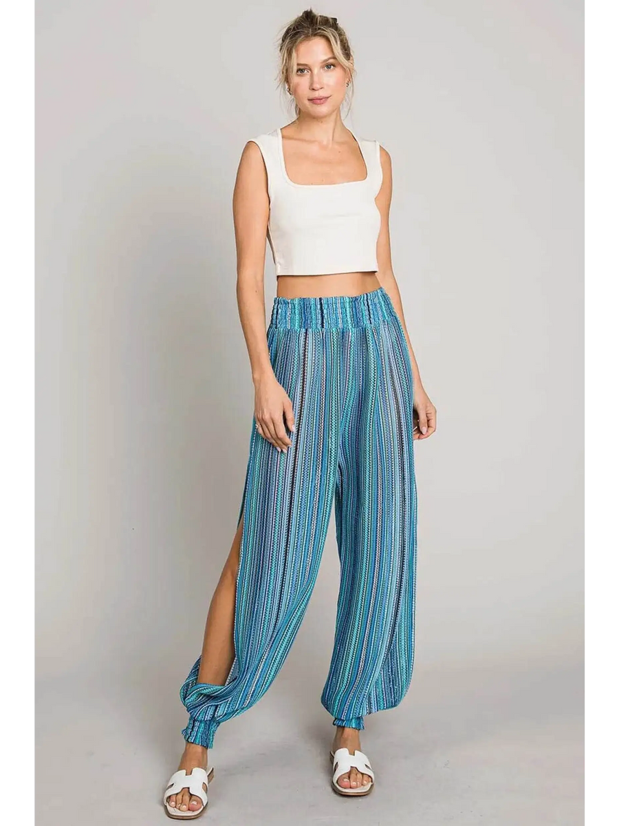 Babe Beachwear blue lightweight open leg beach pants with striped pattern worn with white tank top