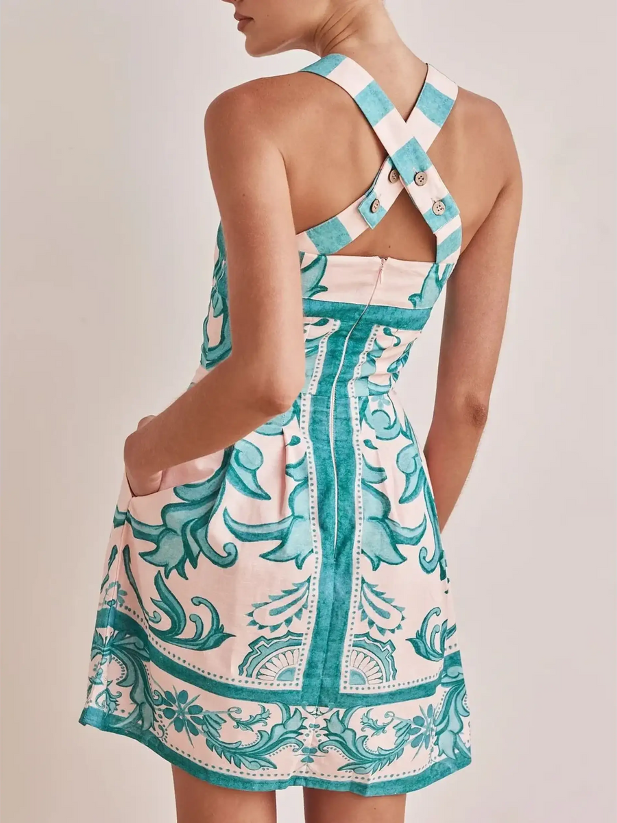 Trendsi blue mini dress with floral print and cross-back straps on model