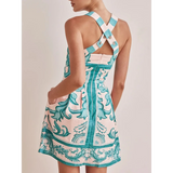 Trendsi blue mini dress with floral print and cross-back straps on model