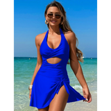 Beach Babes blue sexy cutout swim dress worn by woman on beach with sunglasses and wavy hair