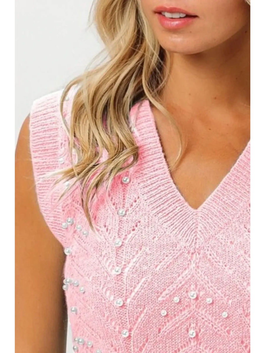 Blush pink sleeveless blouse by Trendsi featuring a V-neck and decorative pearl accents