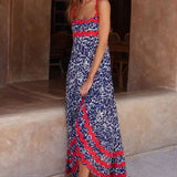 Trendsi boho beach maxi dress with blue and red floral print worn by woman with flower in hair