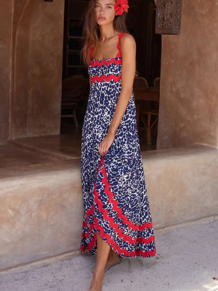 Trendsi boho beach maxi dress with blue and red floral print worn by woman with flower in hair