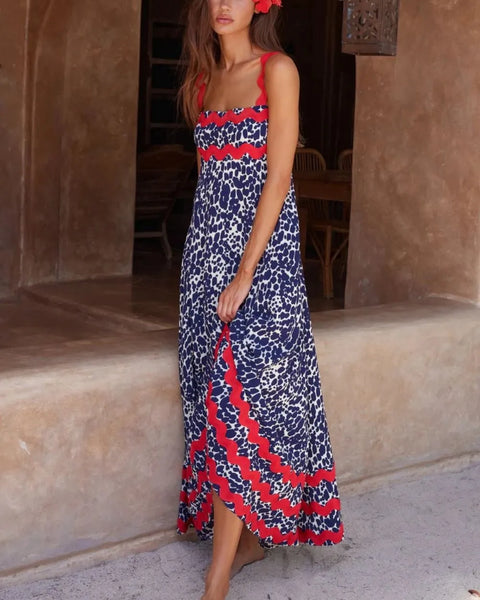 Trendsi boho beach maxi dress with blue and red floral print worn by woman with flower in hair