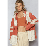 Trendsi boho chic beachwear jacket in rust and cream colors worn over a crop top and skirt