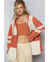 Trendsi boho chic beachwear jacket in rust and cream colors worn over a crop top and skirt