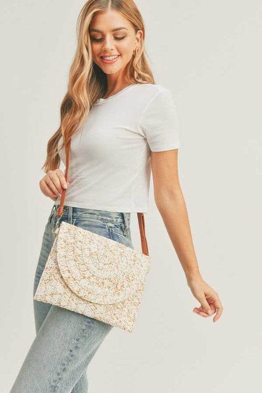 Woman wearing boho ivory clutch bag with intricate pattern and brown strap by Babe Beachwaer