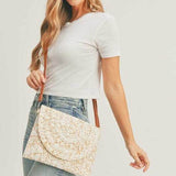 Woman wearing boho ivory clutch bag with intricate pattern and brown strap by Babe Beachwaer