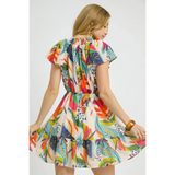 Trendsi orange boho mini dress with colorful floral pattern and ruffled hem worn by woman