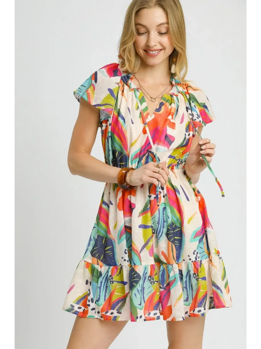 Trendsi orange boho mini dress with colorful leaf print and flutter sleeves on smiling model