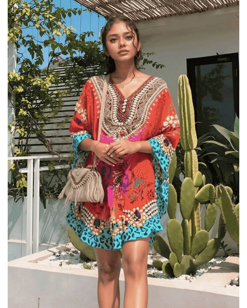 Babe Beachwear boho mini swimsuit coverup in vibrant red and blue with intricate patterns worn by model outdoors