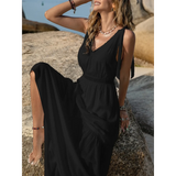 Babe Beachwear black maxi dress worn by woman sitting on rock outdoors summer style