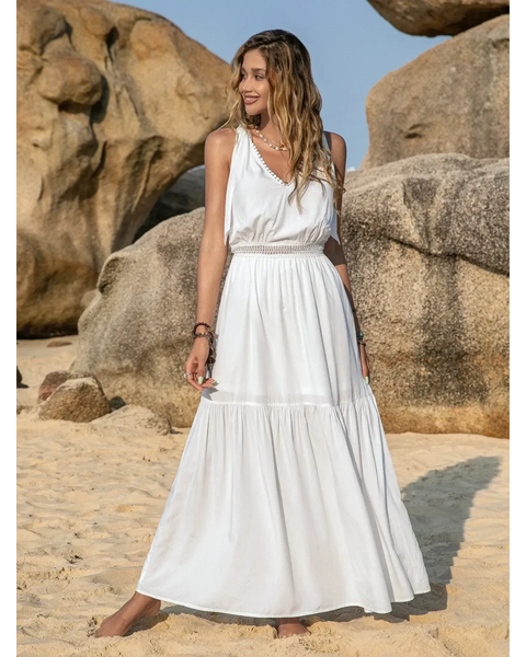 Babe Beachwear Boho summer white crochet dress maxi dress by Trendsi worn by woman on sandy beach with rocks