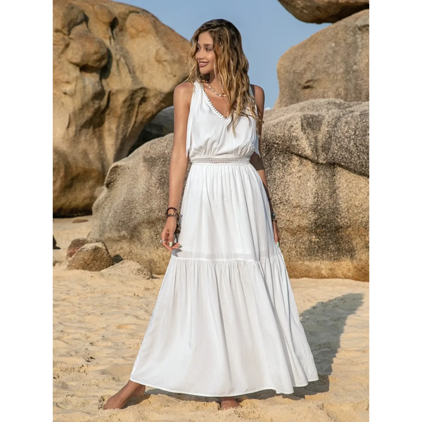 Babe Beachwear Boho summer white crochet dress maxi dress by Trendsi worn by woman on sandy beach with rocks