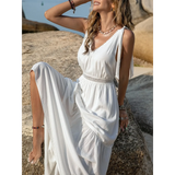 Babe Beachwear boho summer white crochet dress maxi dress worn outdoors on a rocky beach setting