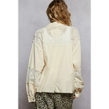 Back view of boho vacation jacket with lace trim in cream from Trendsi worn with leopard print pants