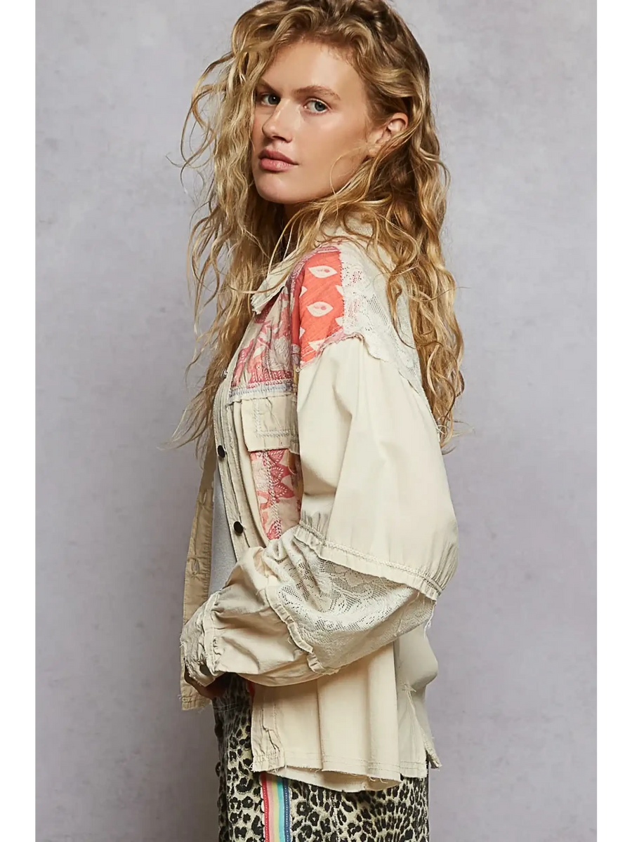 Babe Beachwear a boho vacation jacket with lace trim in cream with coral patterned accents worn by model