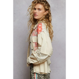 Babe Beachwear a boho vacation jacket with lace trim in cream with coral patterned accents worn by model