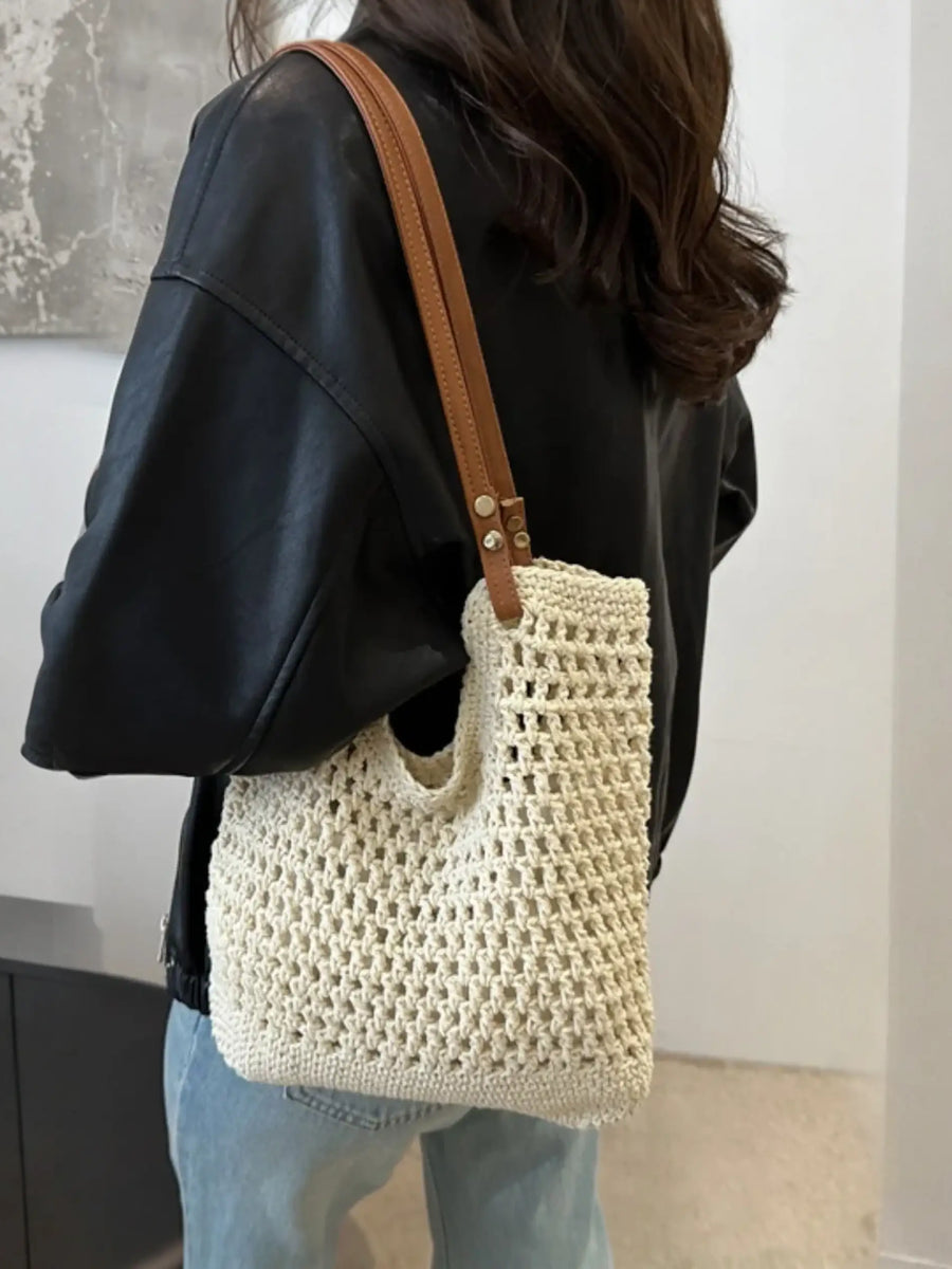 Babe Beachwear braided tote bag with leather straps worn over shoulder with black top and jeans