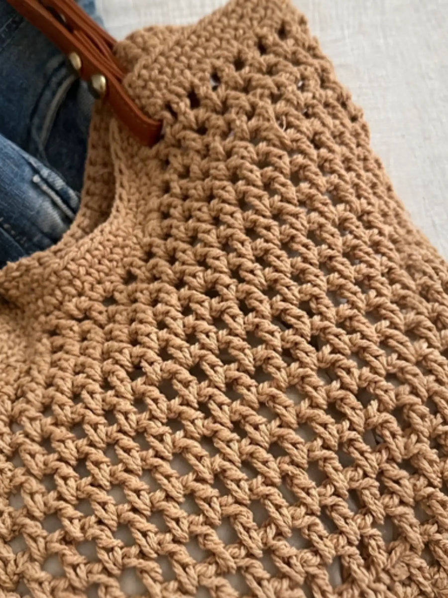 Close-up of a Babe Beachwear braided tote bag with leather straps showing detailed woven texture