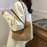 Braided tote bag with leather straps worn over shoulder with white long sleeve shirt