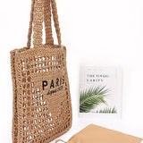 Paris Crochet Straw Summer Tote by Babe Beachwear with open weave design and black printed text
