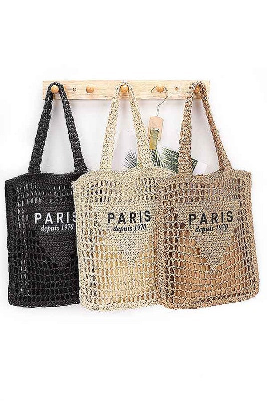 Three Paris Crochet Straw Summer Tote bags in black, beige, and brown hanging on wooden hooks