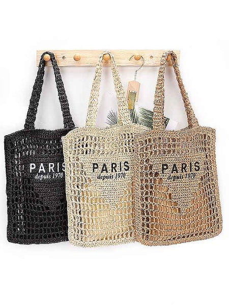 Three Paris Crochet Straw Summer Tote bags in black, beige, and brown hanging on wooden hooks