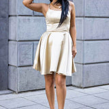 Woman wearing nude block heel summer sandals paired with a light beige sleeveless dress outdoors
