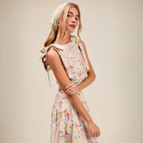 Trendsi floral skirt set worn by woman styled as breathable vacation outfit for women with sleeveless top and flowy skirt