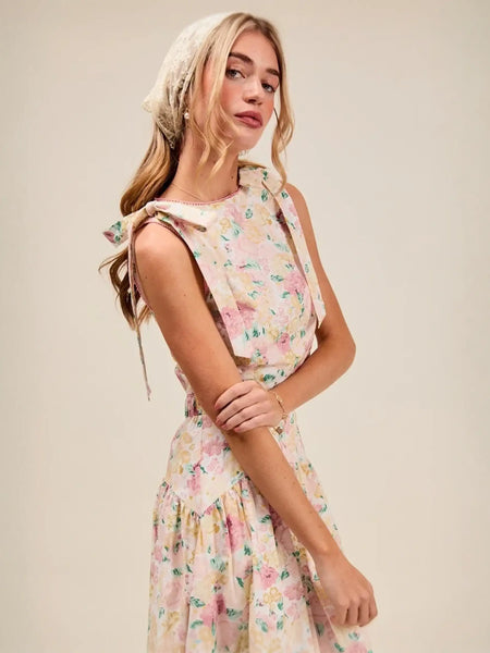 Trendsi floral skirt set worn by woman styled as breathable vacation outfit for women with sleeveless top and flowy skirt