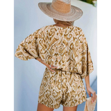 Babe Beachwear blue batwing romper for travel with loose sleeves and animal print design