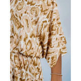 Babe Beachwaer blue batwing romper for travel with loose fit and patterned fabric on model's arm