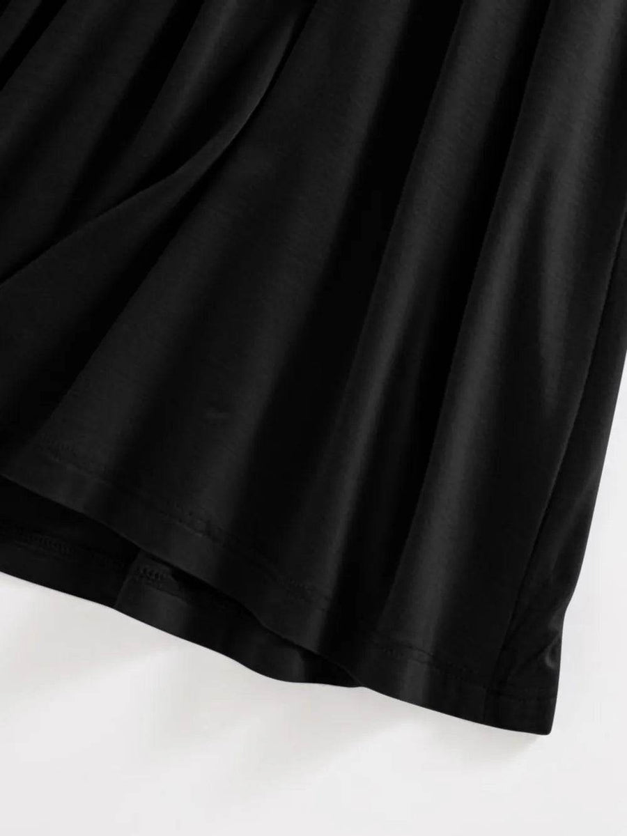 Close-up of black fabric and hem detail of Trendsi Built-In Bra Shelf Midi Dress