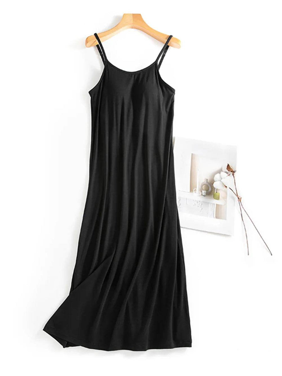Trendsi black Built-In Bra Shelf Midi Dress with spaghetti straps hanging on a wooden hanger