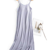 Trendsi light purple Built-In Bra Shelf Midi Dress with spaghetti straps hanging on wooden hanger