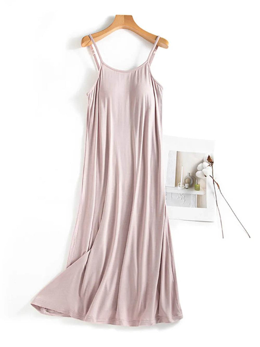 Trendsi light pink sleeveless Built-In Bra Shelf Midi Dress with a flowing design on a wooden hanger