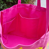 Bright pink Babe Beachwear canvas beach tote bag interior showing large open compartments