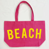 Pink Canvas Beach Tote bag by Babe Beachwaer with large yellow BEACH text and dual shoulder straps