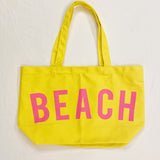 Babe Beachwear yellow Canvas Beach Tote with pink BEACH text and shoulder straps