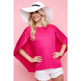 Trendsi pink short sleeve Cape Style Shirt with flowing cape sleeves worn with white shorts and a white hat