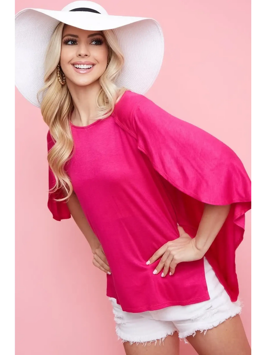 Trendsi pink short sleeve Cape Style Shirt with flowy cape sleeves worn with white shorts and a white hat
