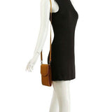 Babe Beachwear cell phone crossbody chain bag in brown worn with black sleeveless dress on mannequin