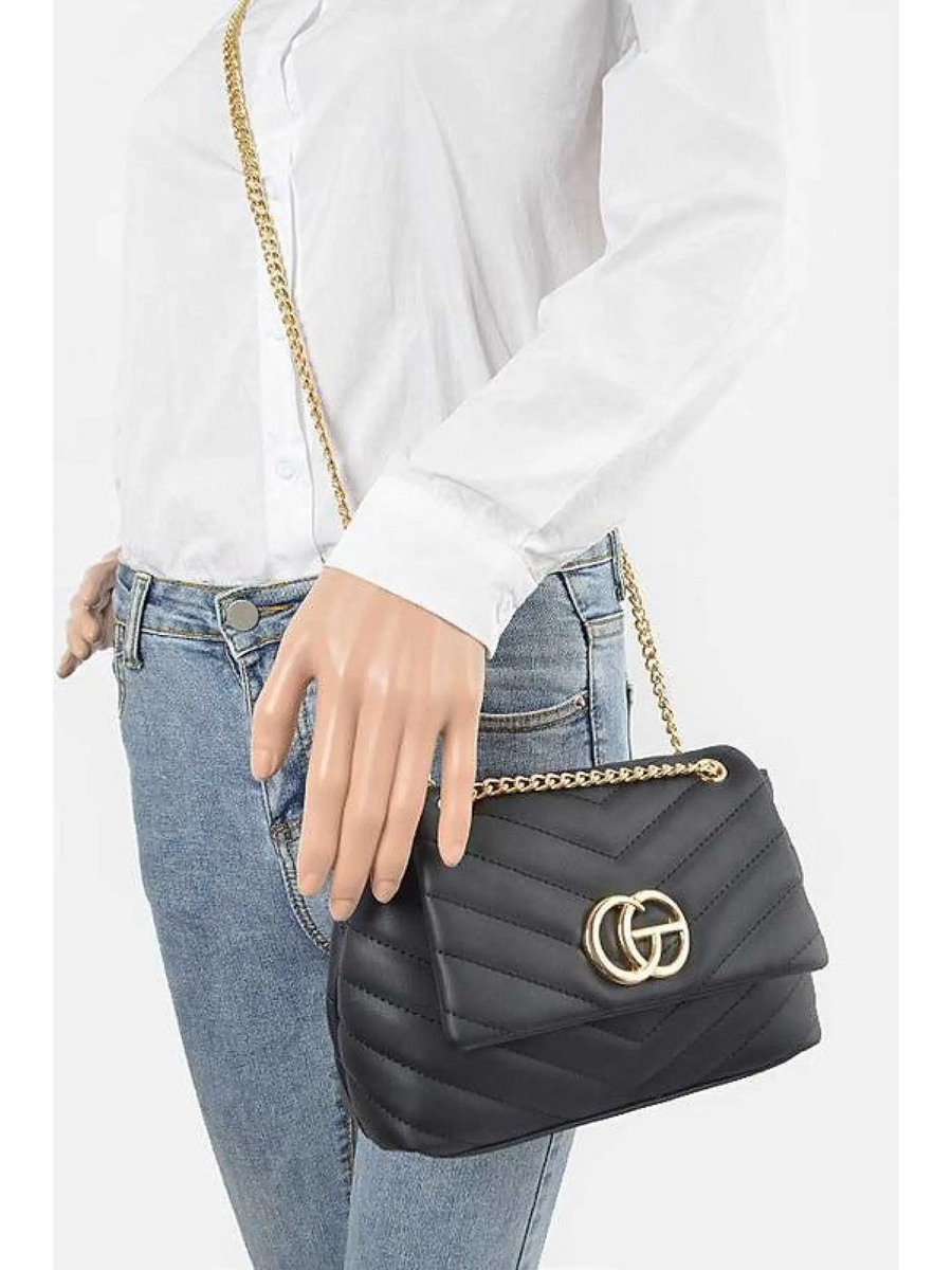 CG Logo Quilted Shoulder Bag in black with gold chain strap worn with white shirt and blue jeans