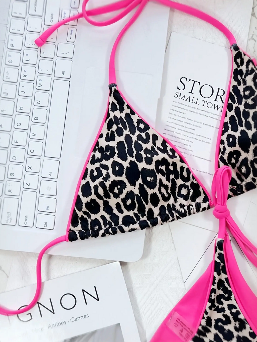 Beach Babes cheeky bottom triangle swimsuit with leopard print and bright pink trim on marble surface